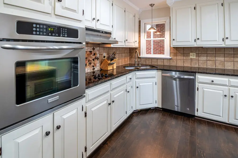 Kitchen with white painted cabinets and stainless appliances