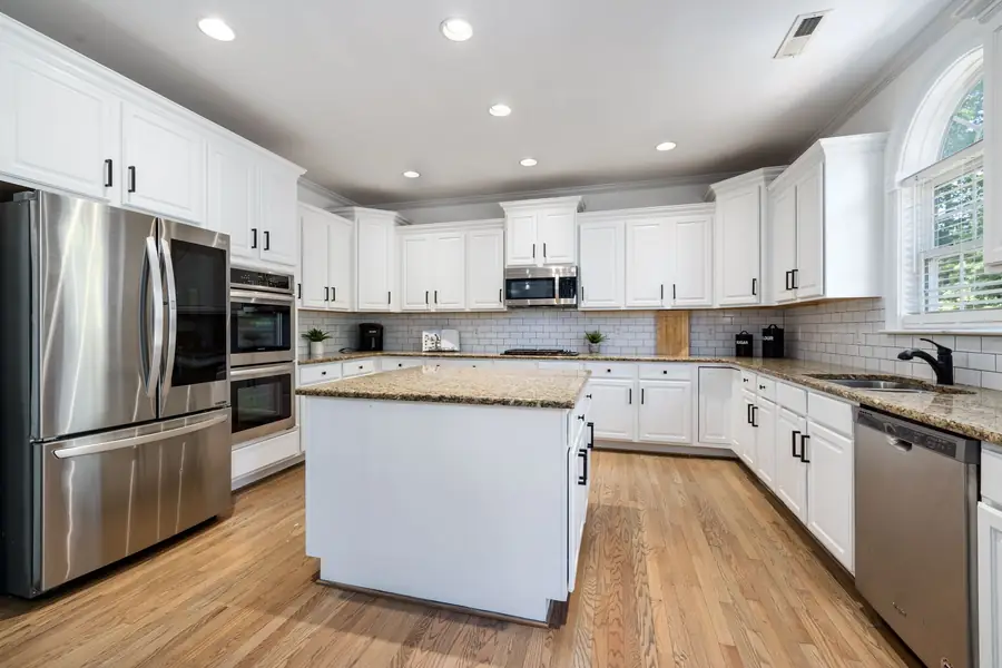 Bright kitchen with white cabinets and light painted walls