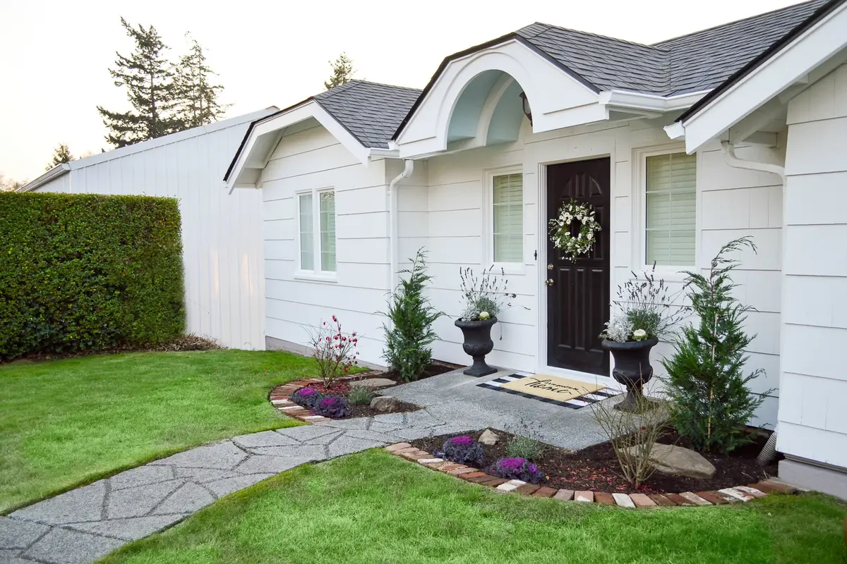 White single-story home with an arched front entry after an exterior repaint